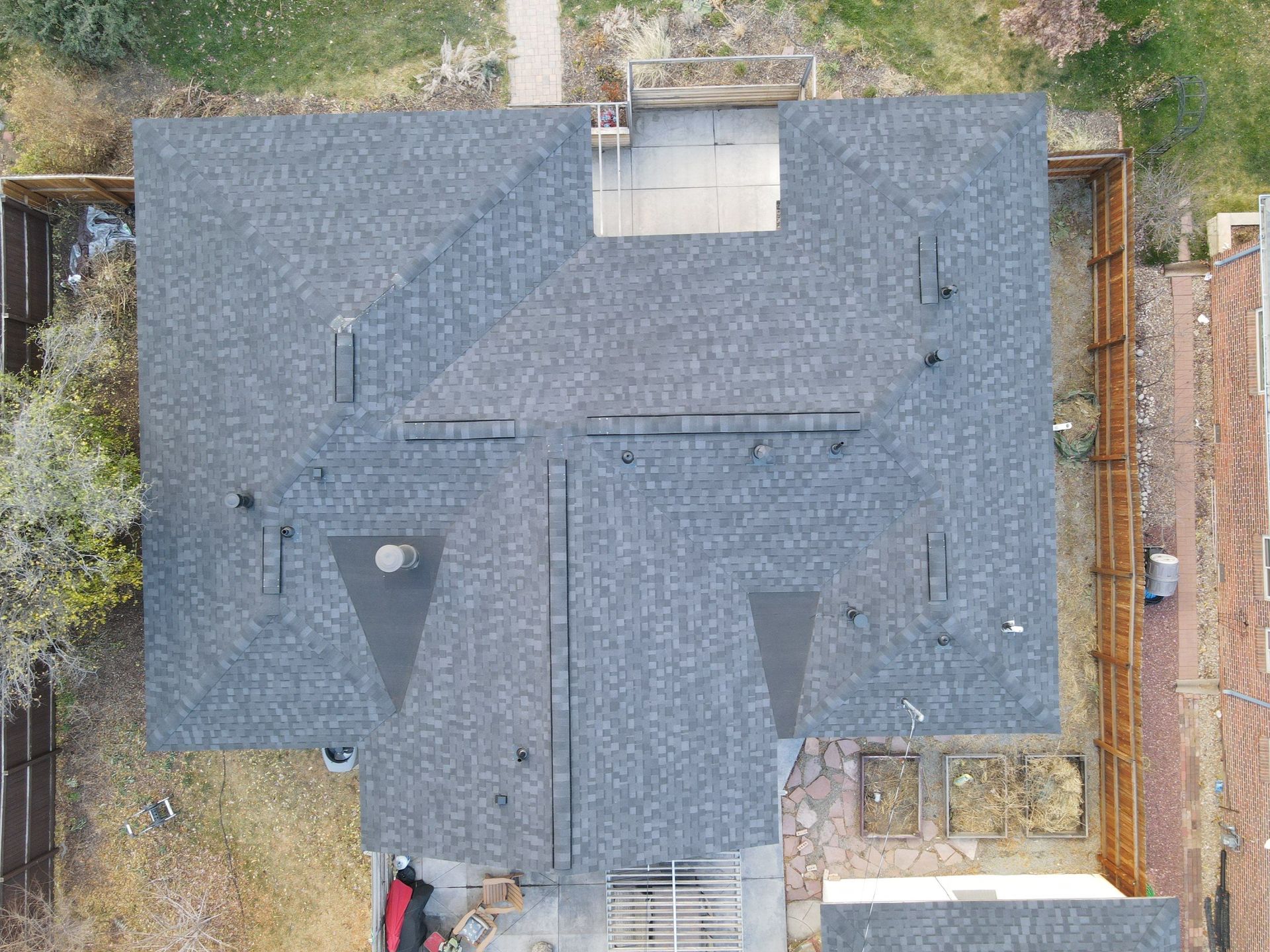 An aerial view of a house with a new roof.