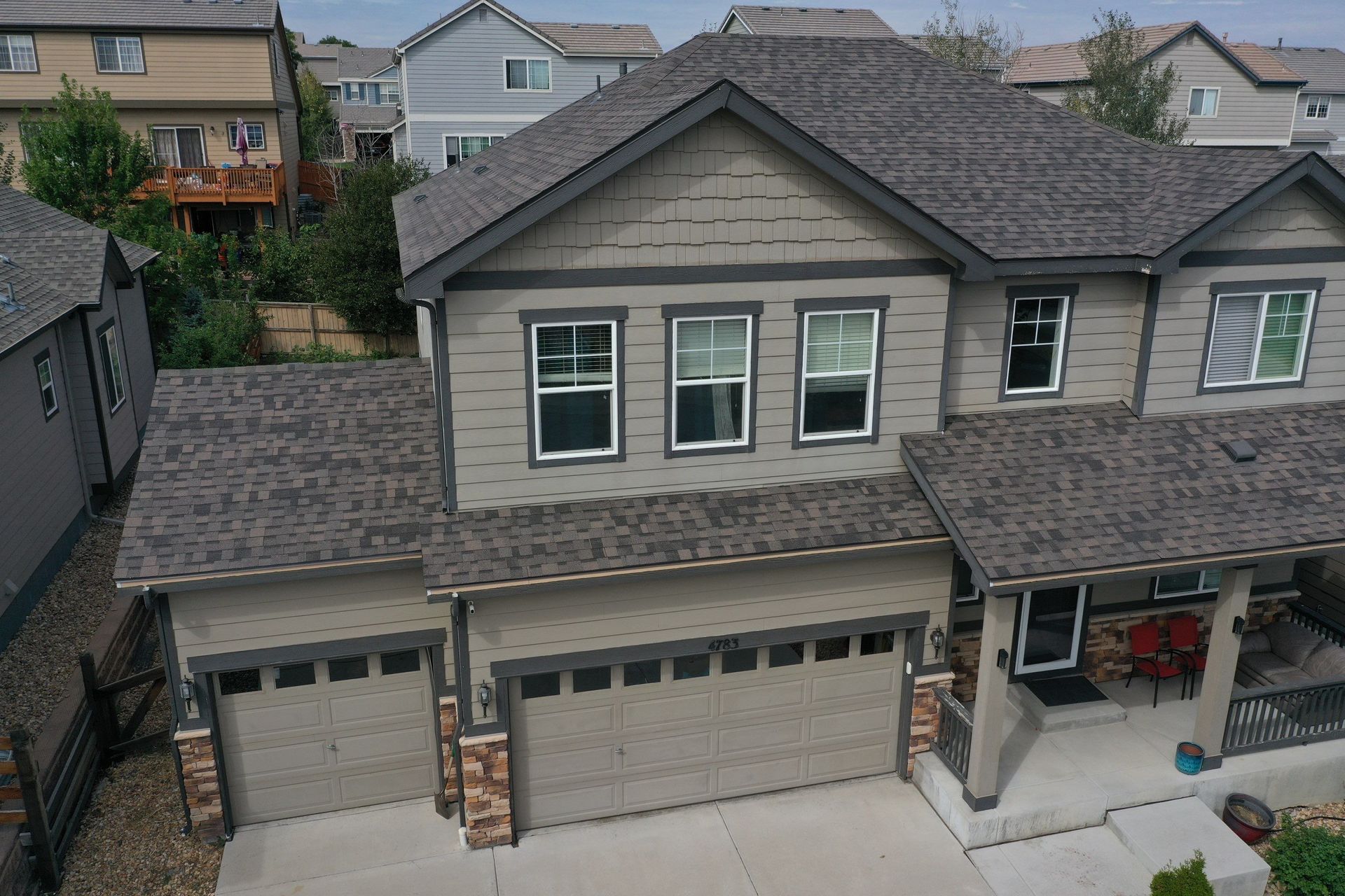 An aerial view of a house with a gray roof