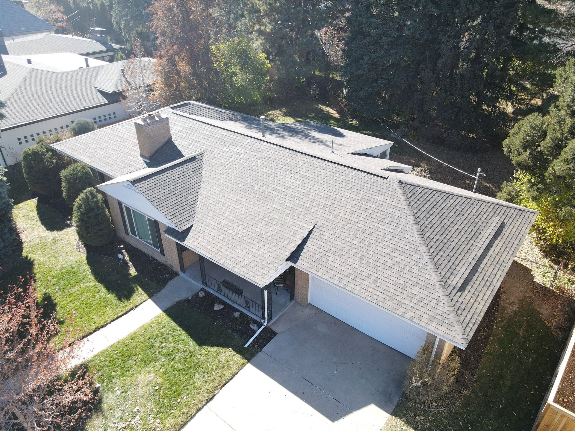 An aerial view of a house with a gray roof