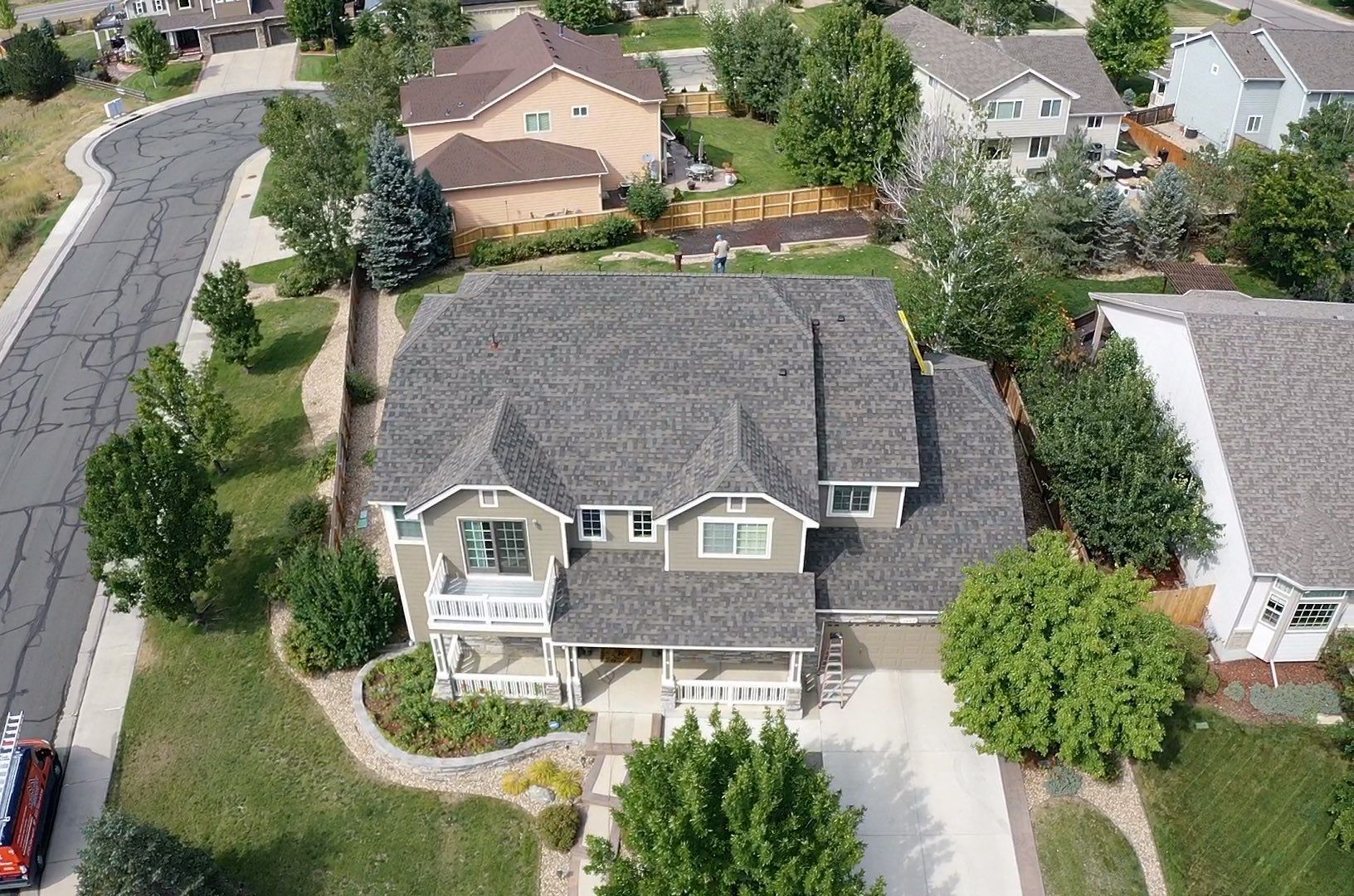 An aerial view of a large house in a residential area