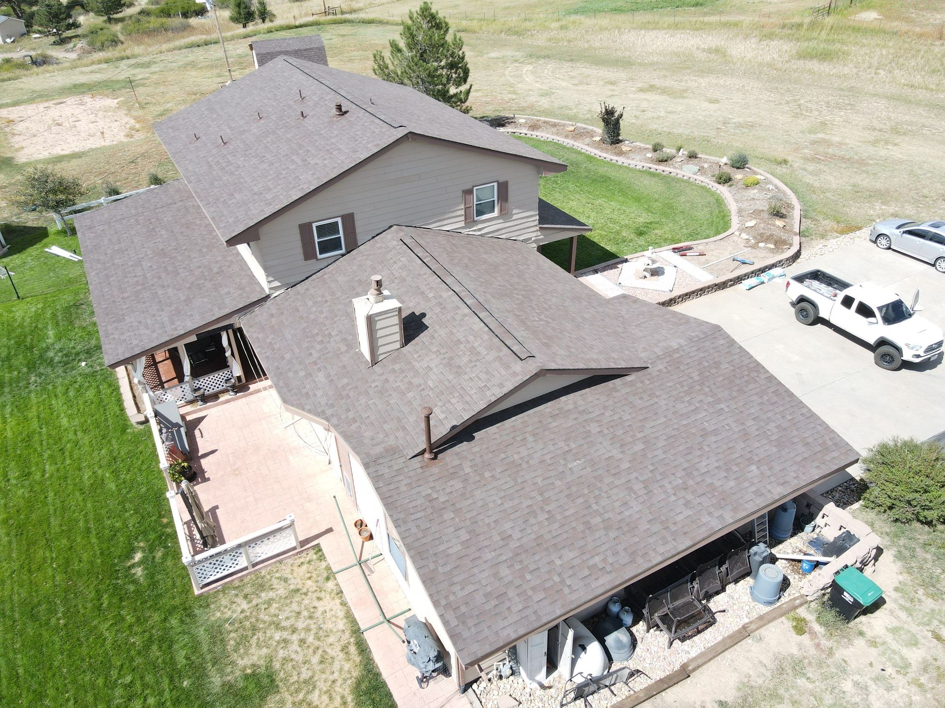 An aerial view of a house with a truck parked in front of it.