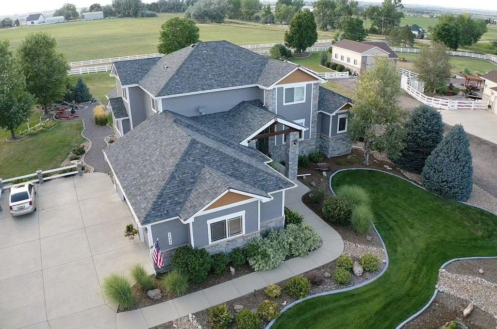 an aerial view of a large house with a large driveway