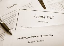 Estate planning documents including a Living Will, Healthcare Power of Attorney, and an advance directive with a pen.