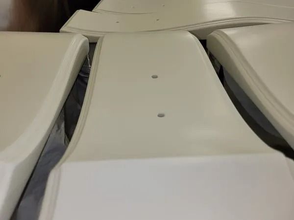 Several smooth, white, rectangular panels with rounded edges, arranged side-by-side.