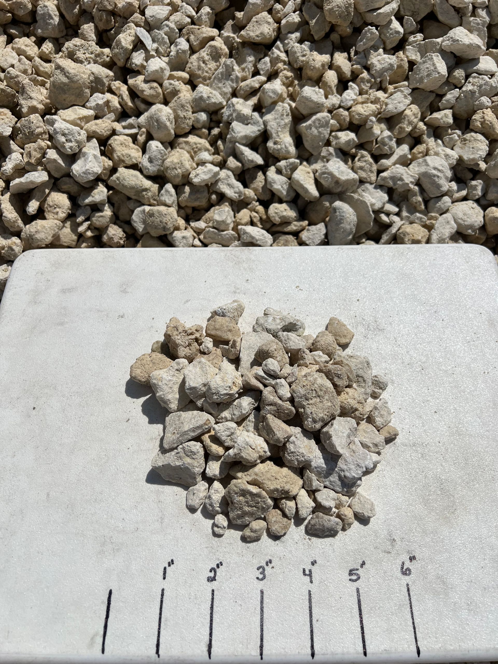 A pile of 57 Limestone sitting on top of a white surface