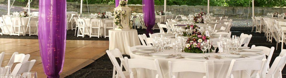 White-tables-and-chairs-with-purple-drapes.