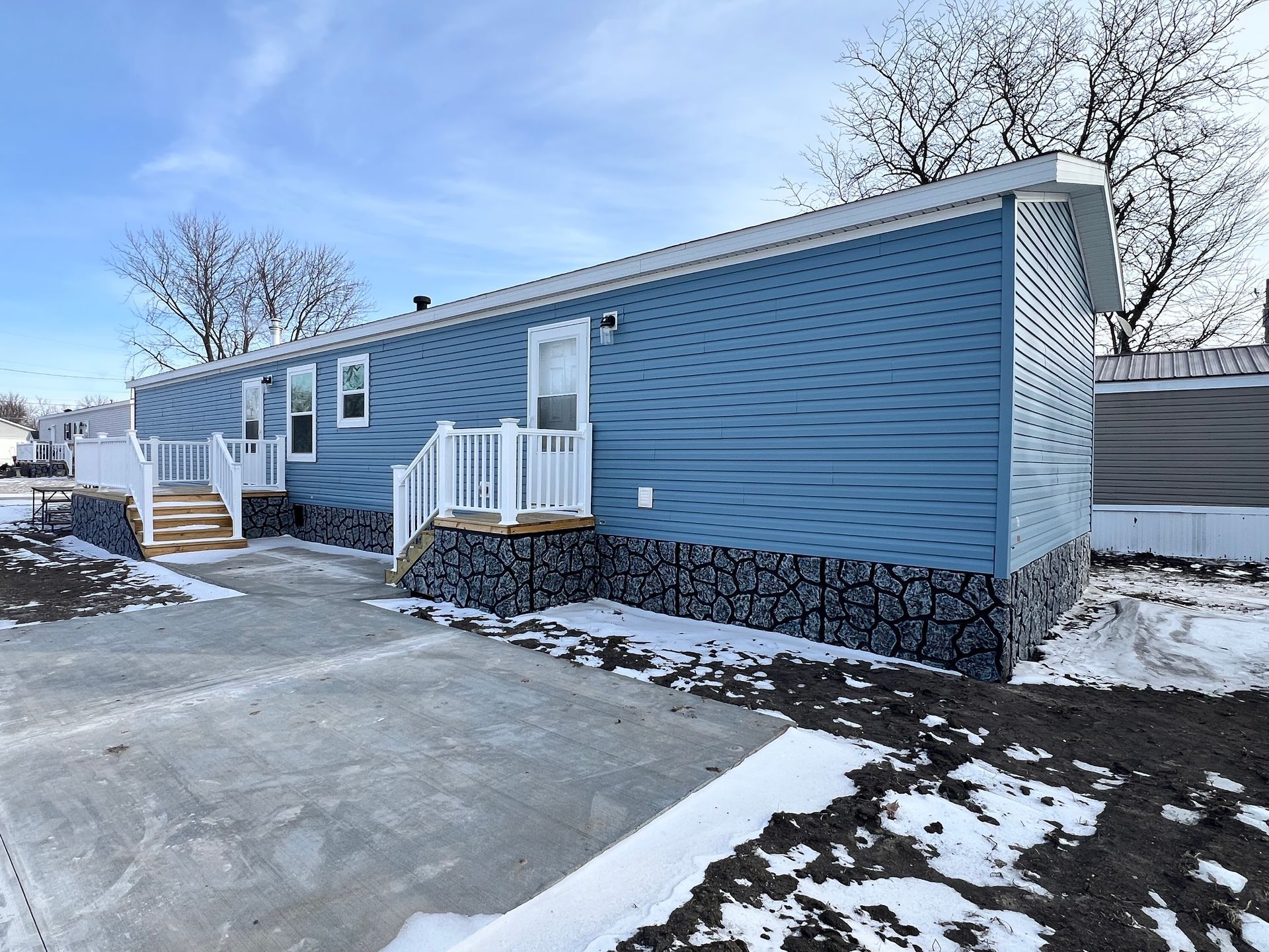 Floor plan of a rectangular house with master bedroom, kitchen, living room, and two other rooms.