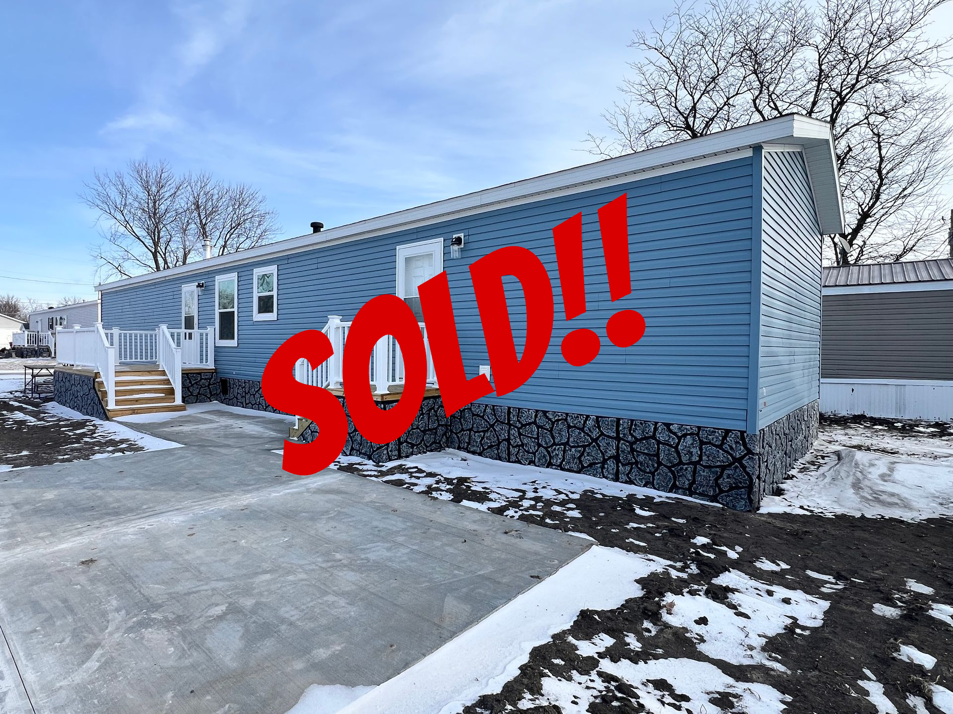 Floor plan of a rectangular house with master bedroom, kitchen, living room, and two other rooms.