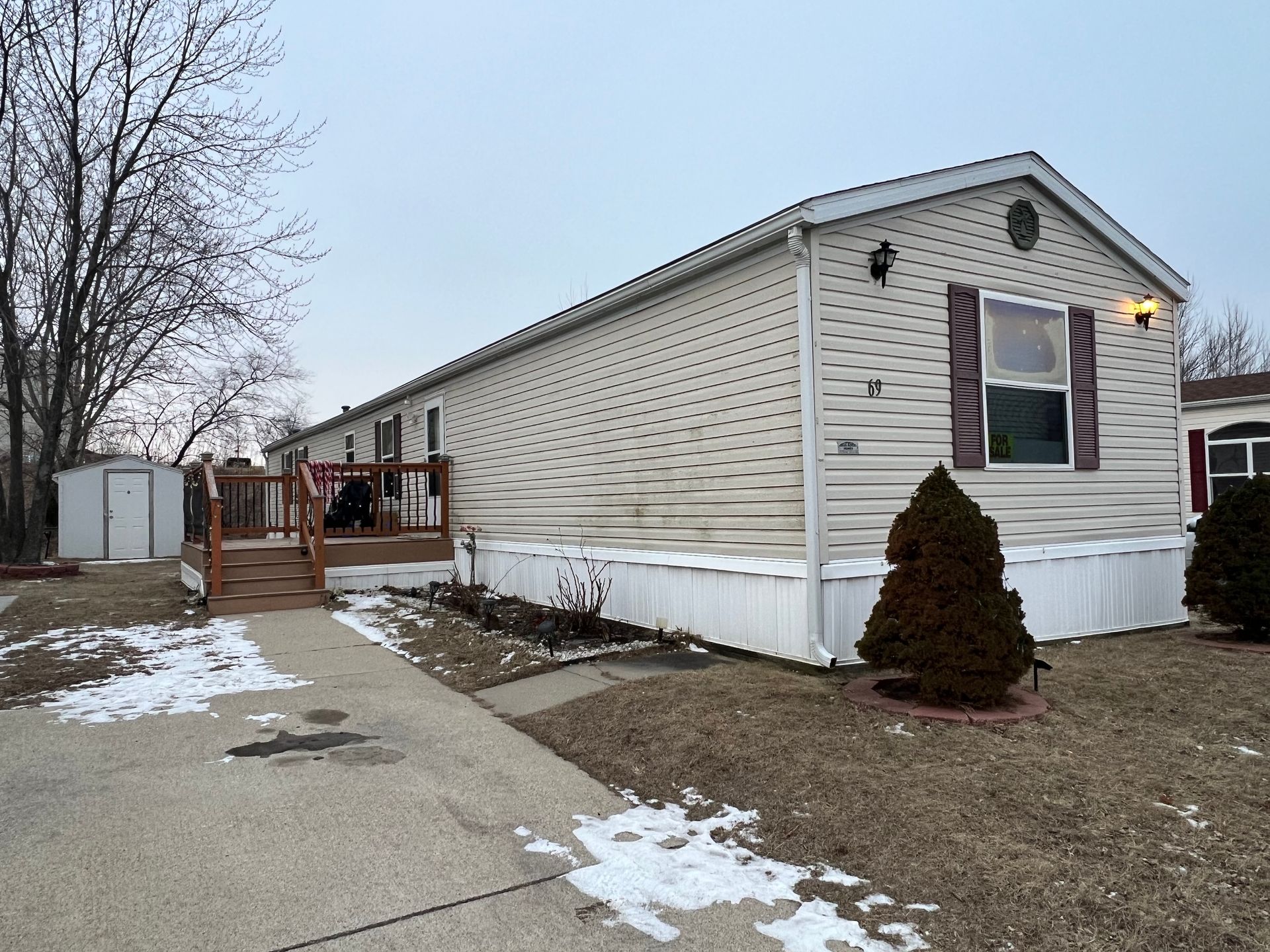 Three stylized houses, with the center one having a chimney and window.