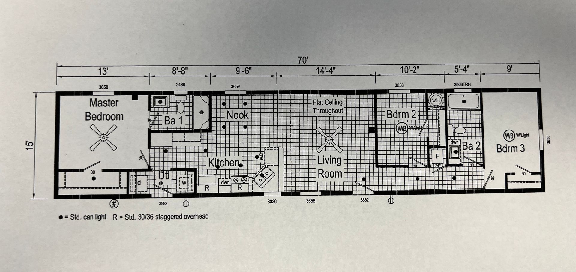 Tan mobile home with steps and a window, against a cloudy sky.