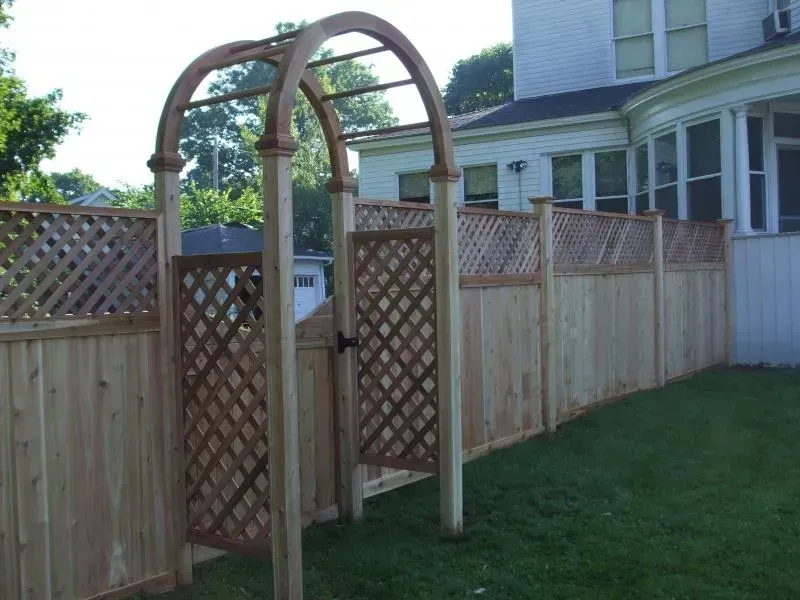 A wooden fence with a wooden arch in the middle