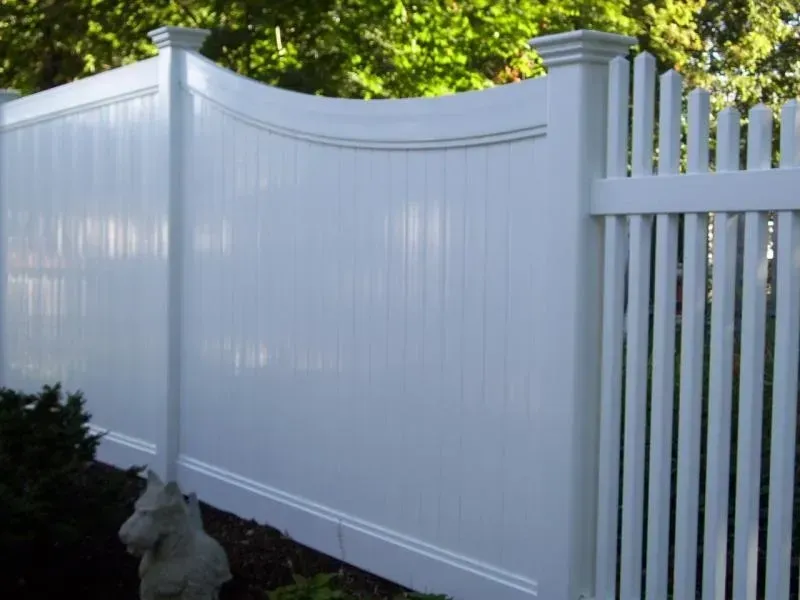 A white picket fence with a horse statue in front of it