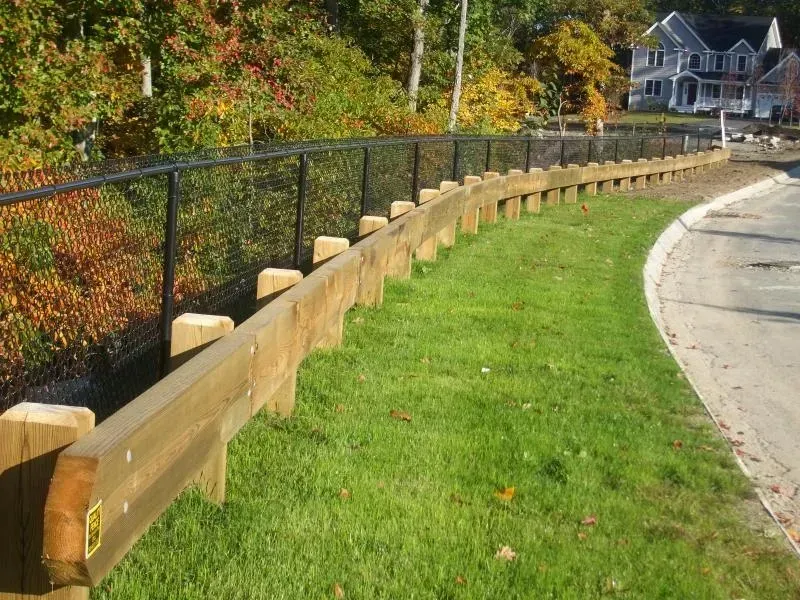A wooden fence along the side of a road