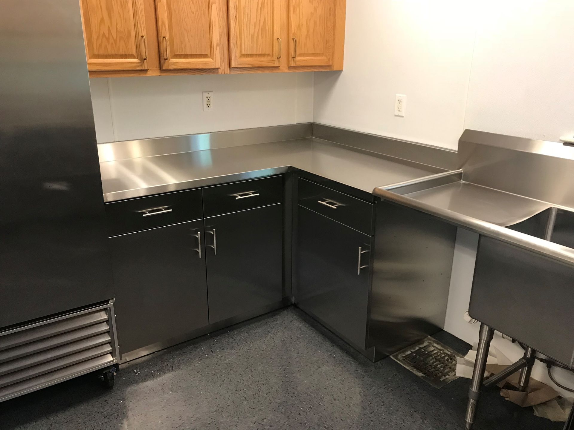 A kitchen with stainless steel cabinets and a sink.