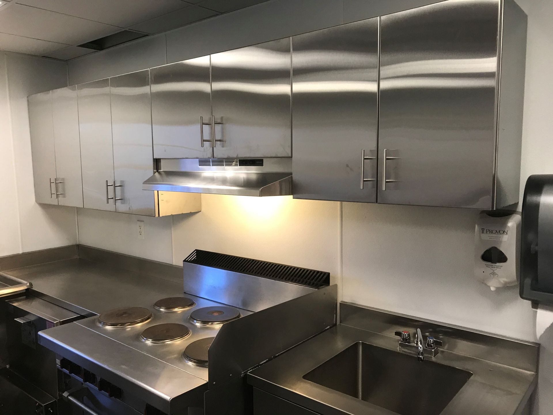 A kitchen with stainless steel cabinets and a sink.