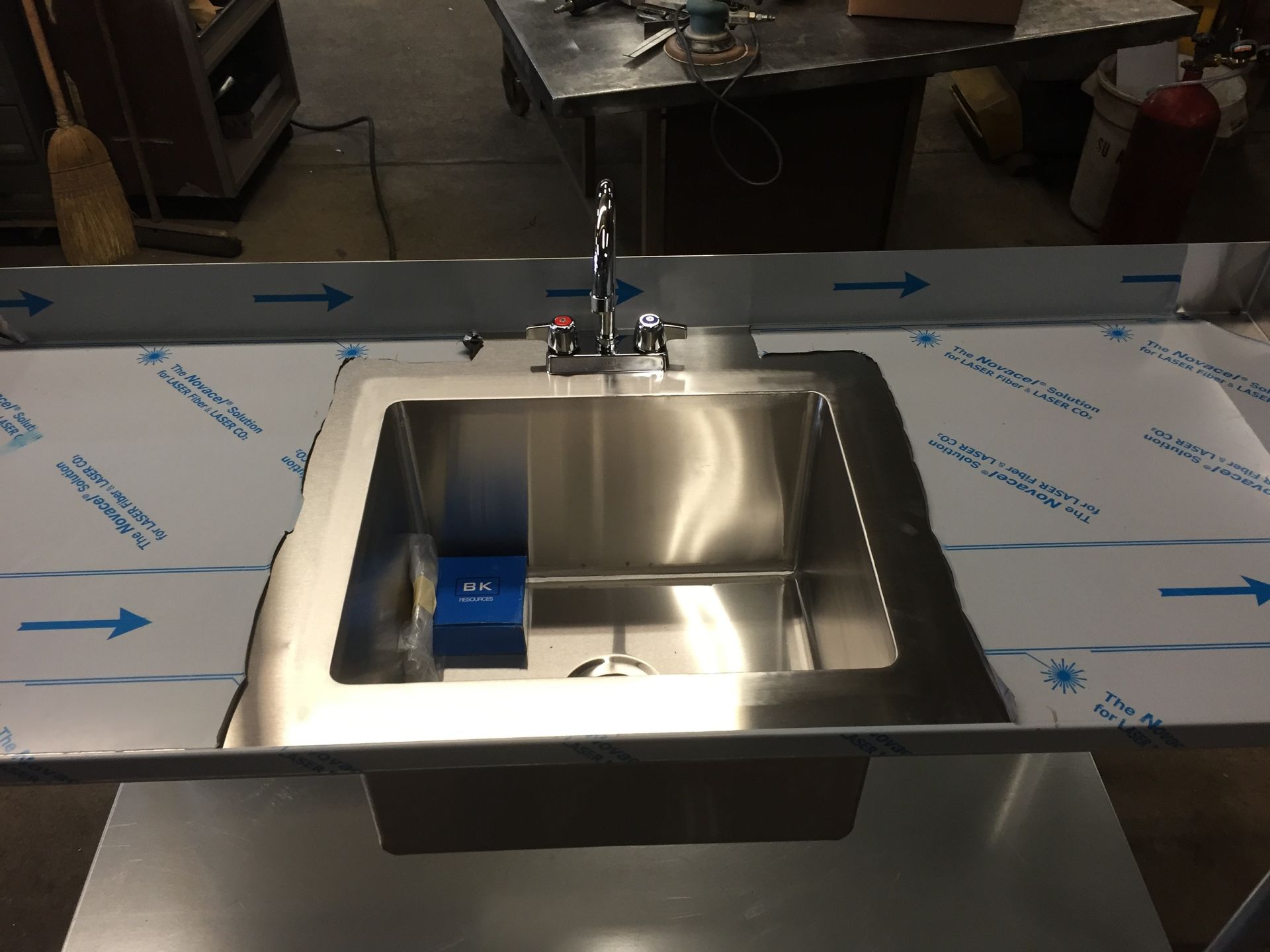 A stainless steel sink is sitting on top of a counter.