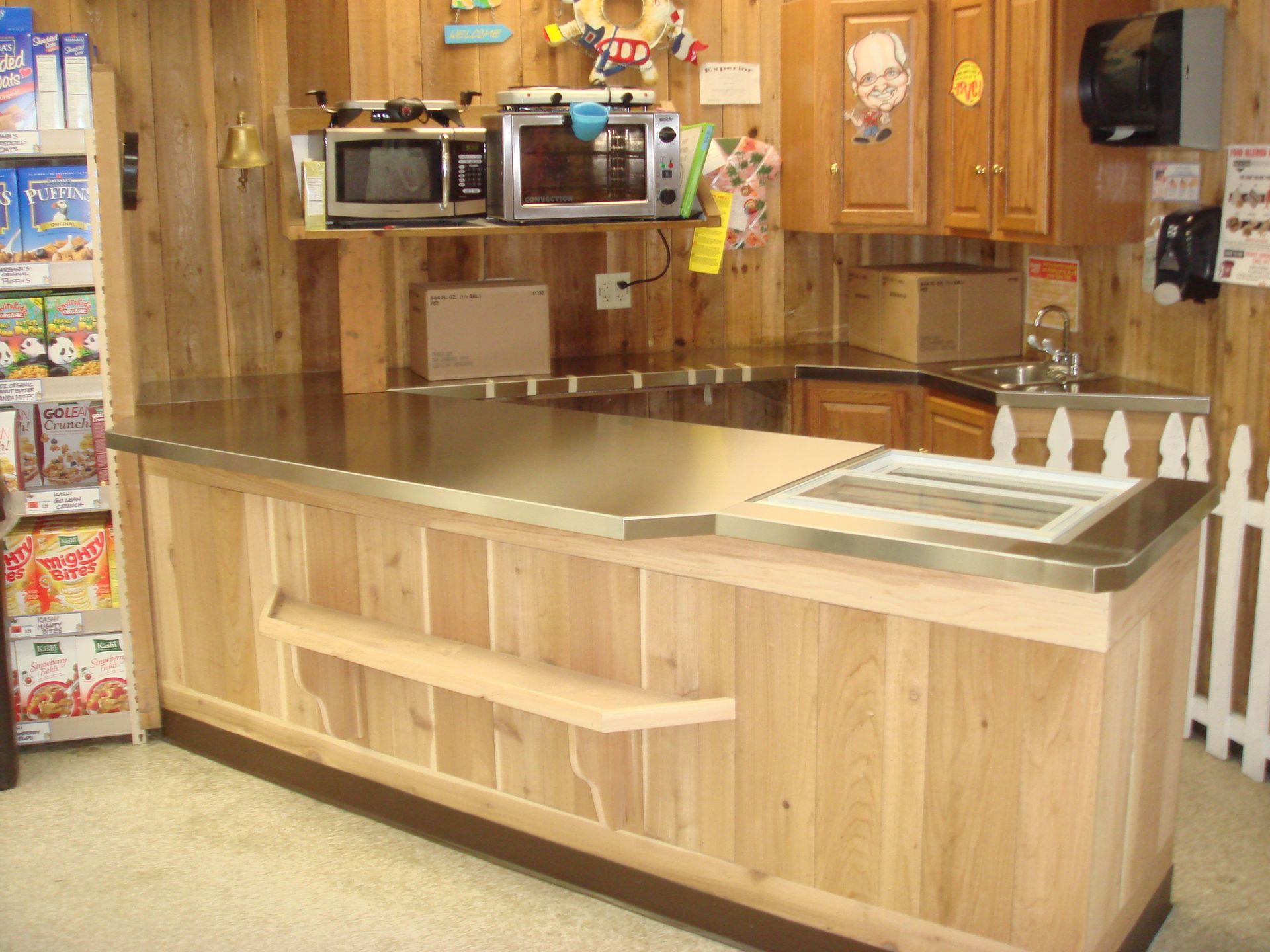 A kitchen with wooden cabinets and a stainless steel counter top