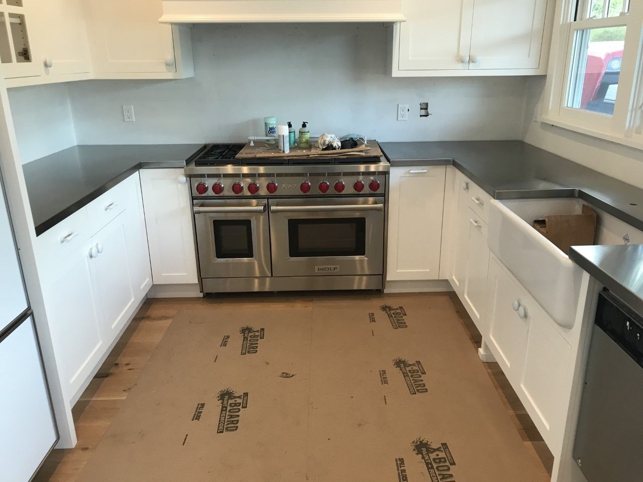 A kitchen with stainless steel appliances and white cabinets