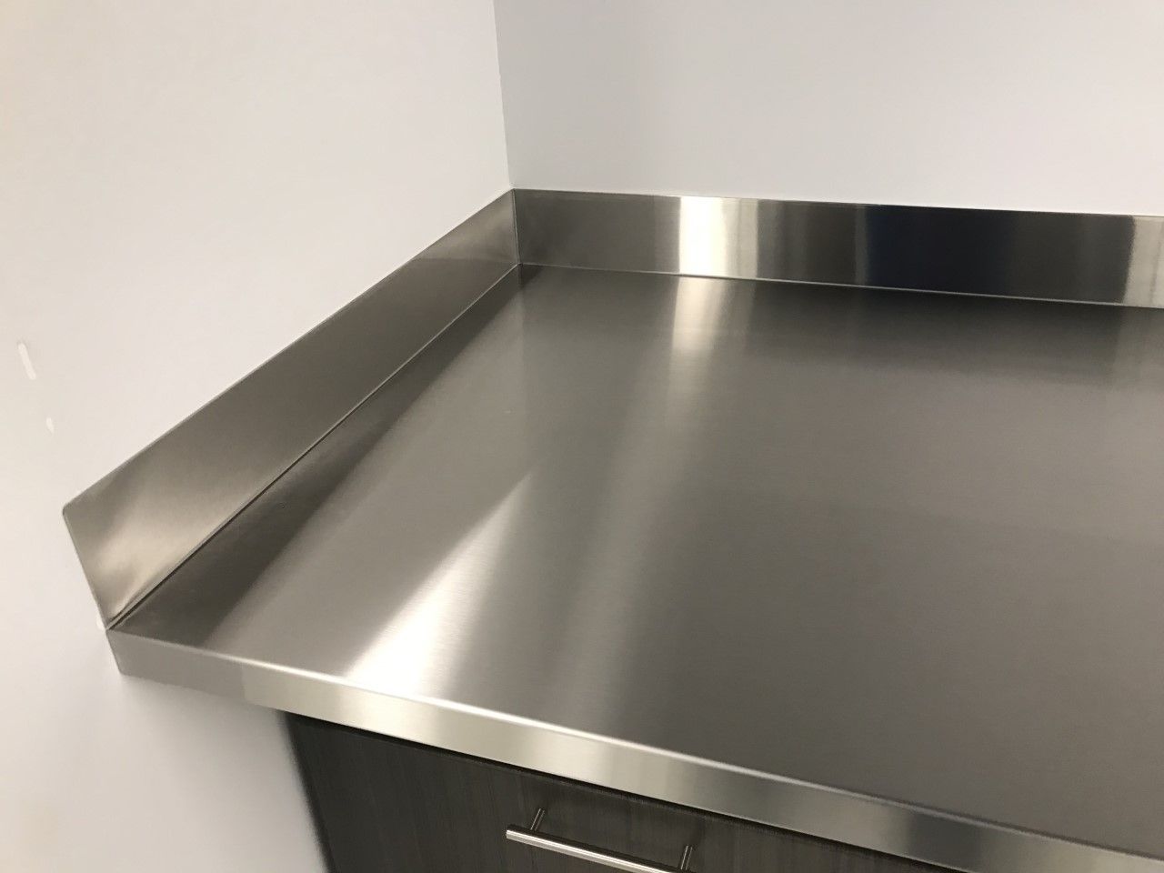 A close up of a stainless steel counter top in a kitchen