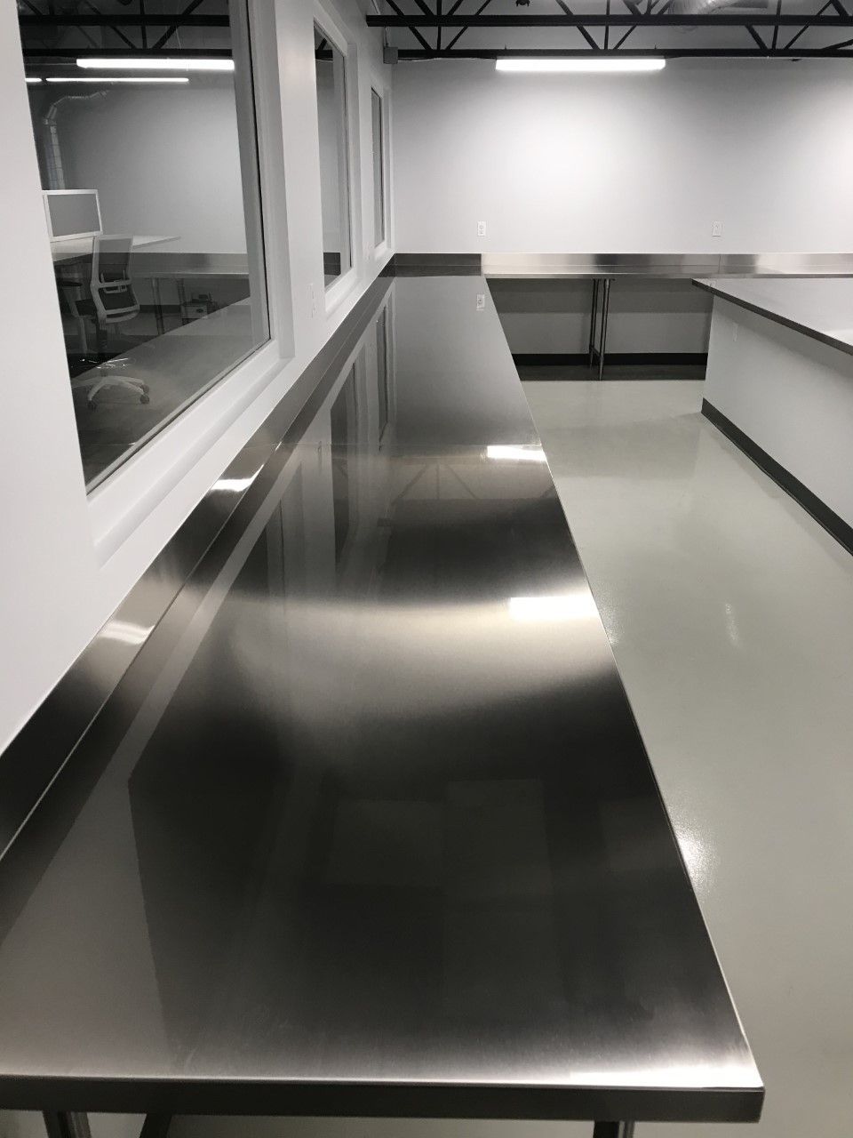 A long stainless steel counter in a kitchen