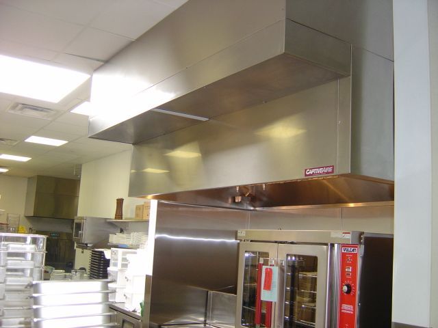 A kitchen with a stainless steel hood that says cambridge on it