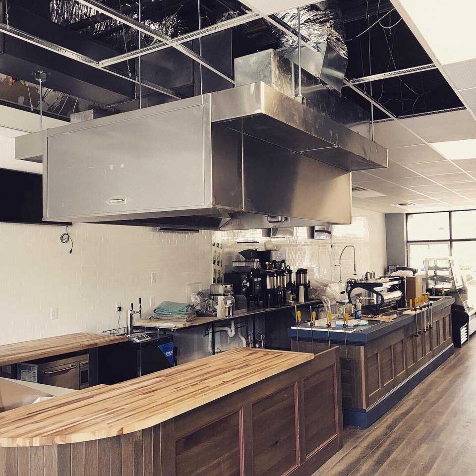 A kitchen with stainless steel appliances and wooden counter tops