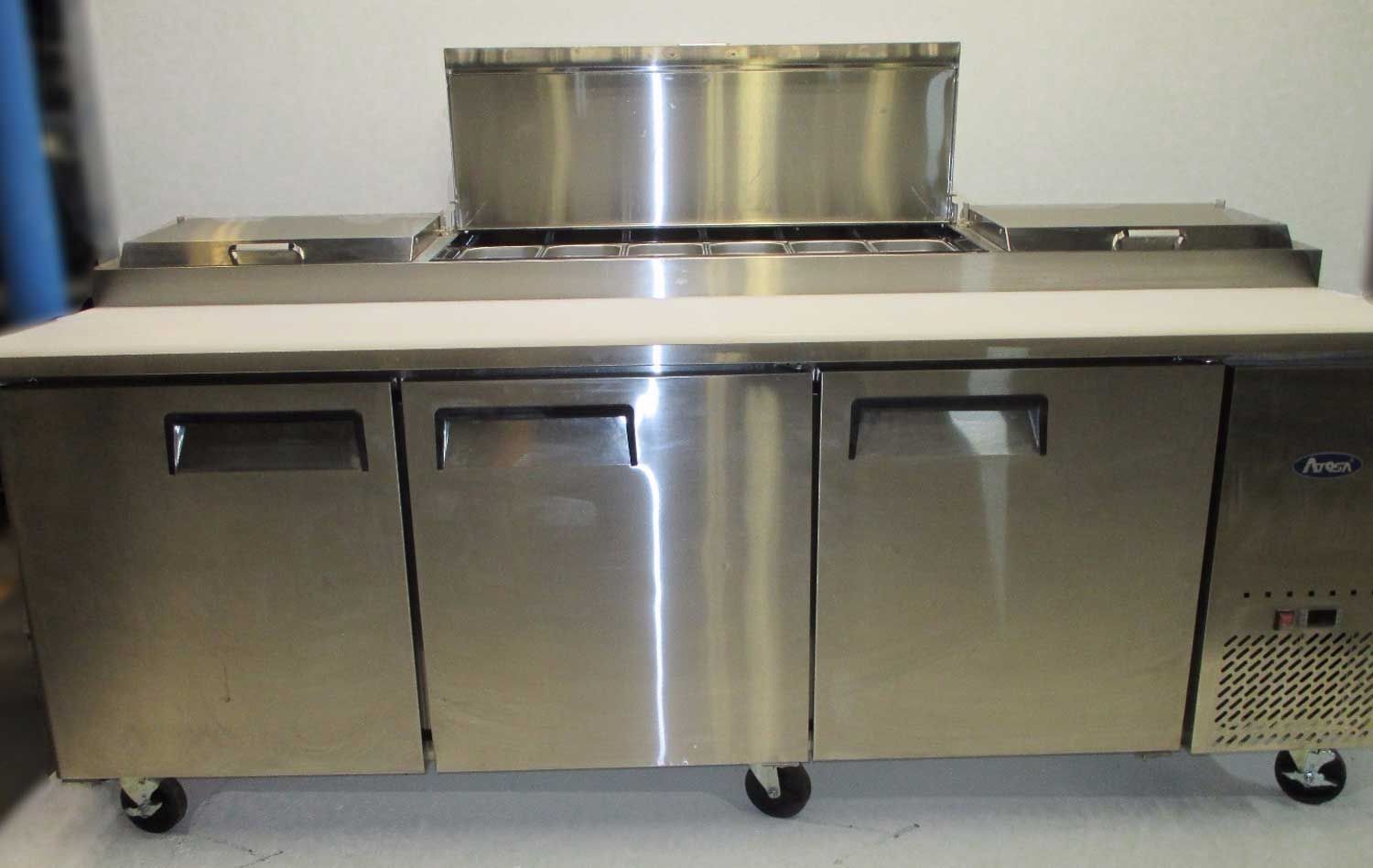 A stainless steel refrigerator with a stainless steel counter top