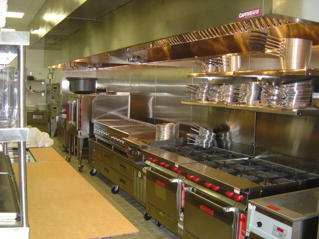 A kitchen with stainless steel appliances and a sign that says order here