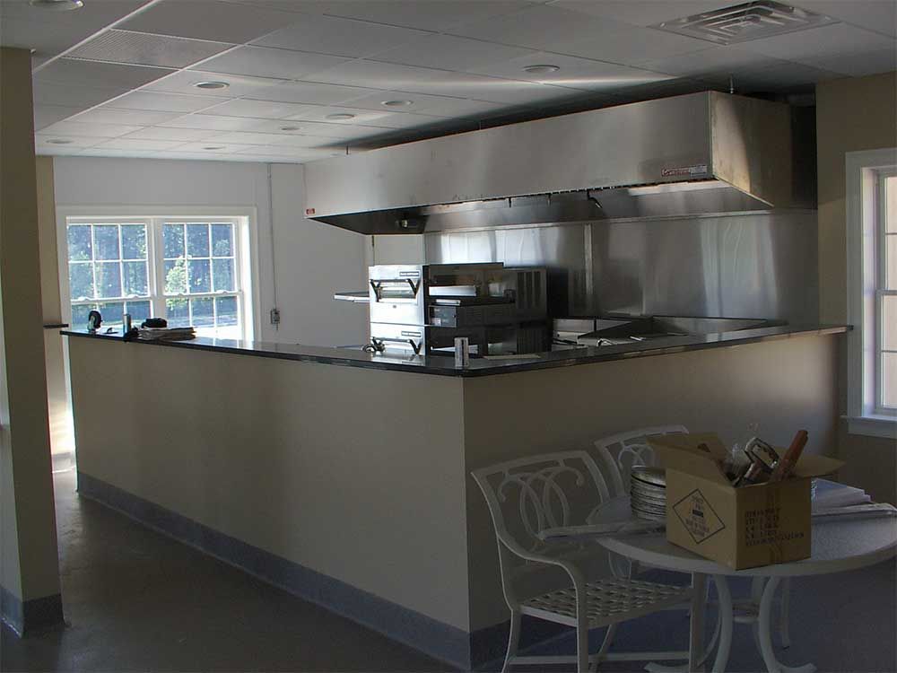 A kitchen with stainless steel appliances including a pizza oven