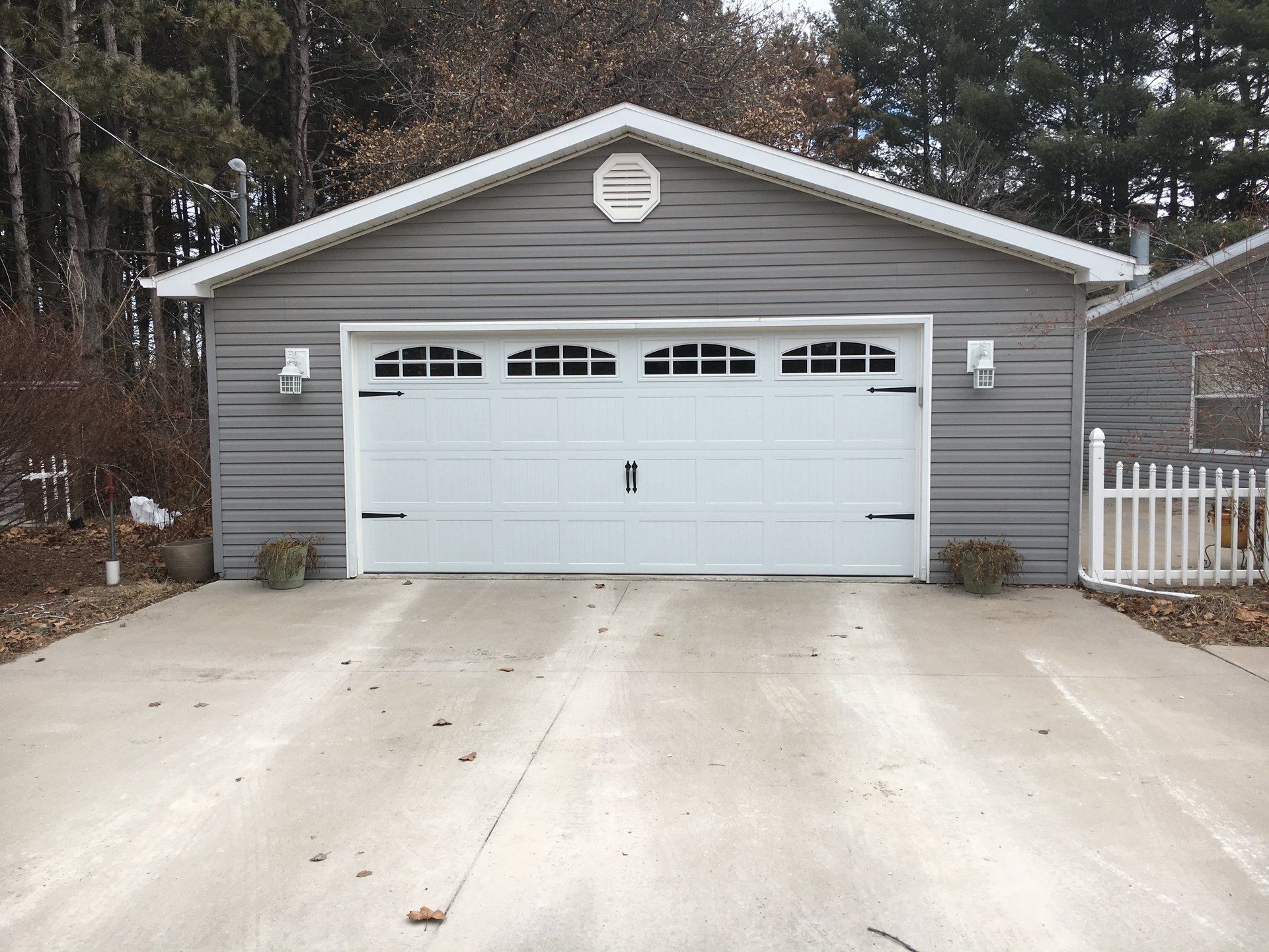 A garage with a white door and a white roof
