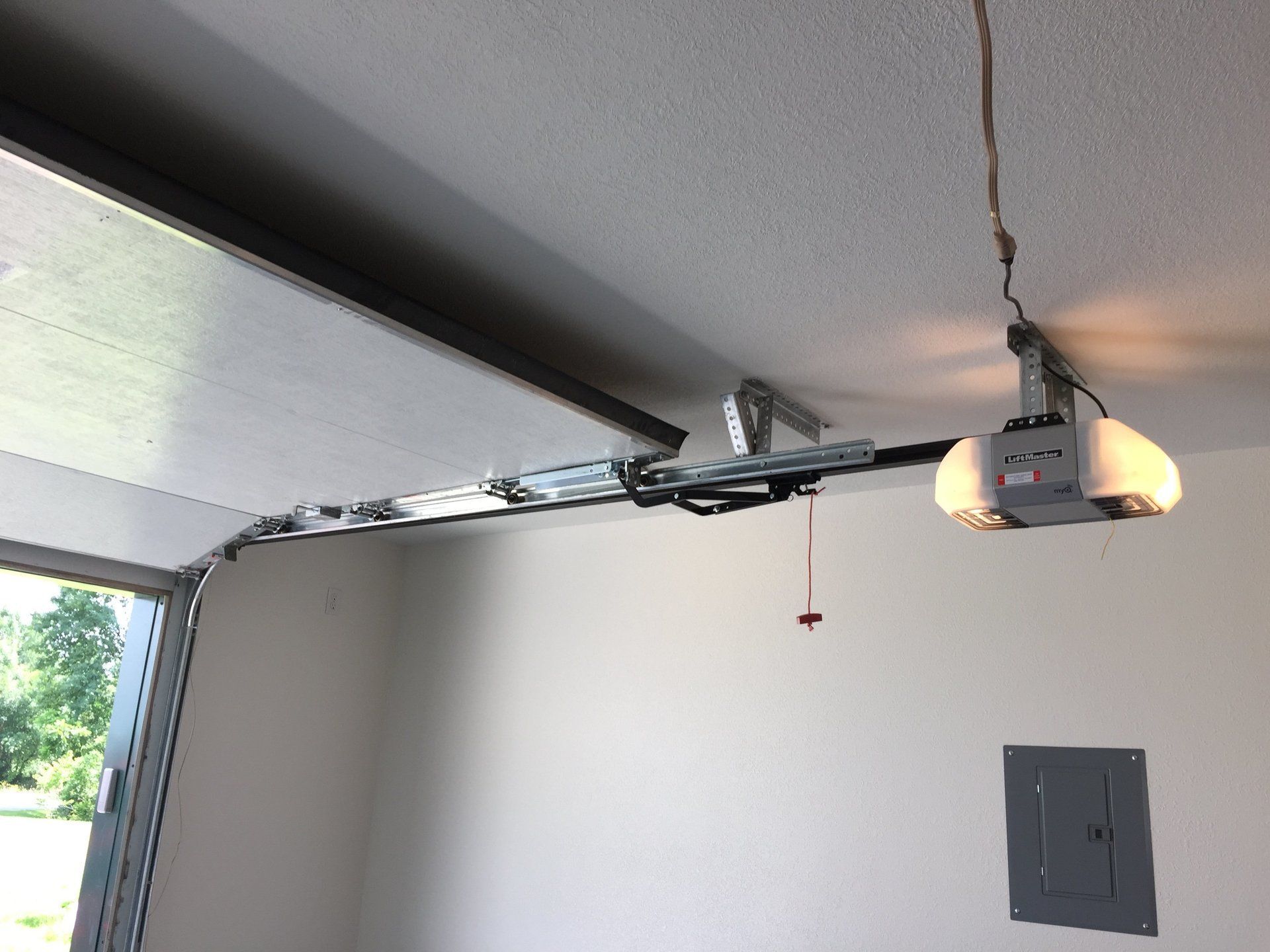 A garage door opener is hanging from the ceiling
