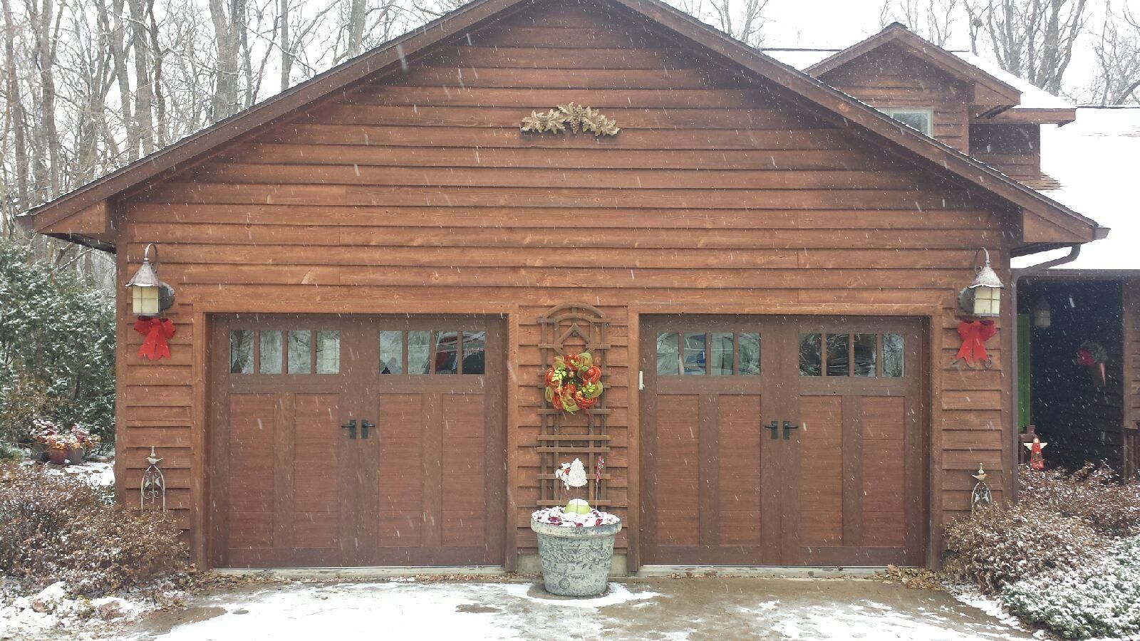 A wooden garage with a wreath on the front of it.