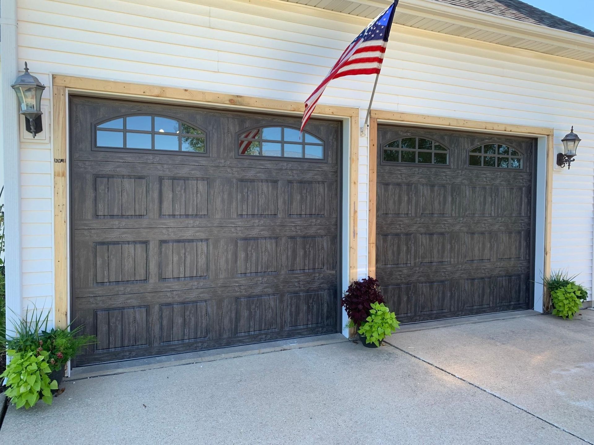 A garage door with an american flag hanging from it.