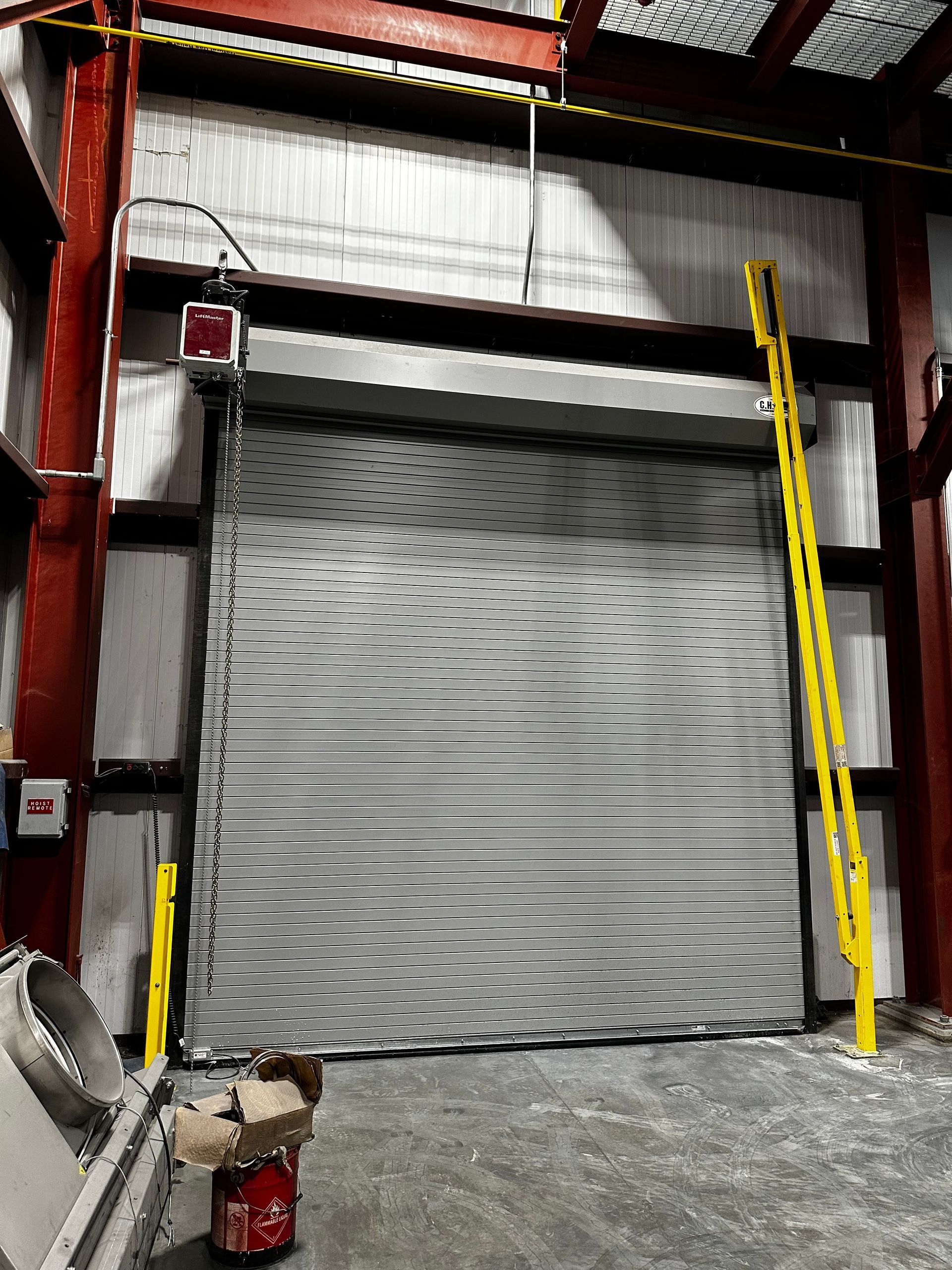 A large garage door with a yellow ladder attached to it