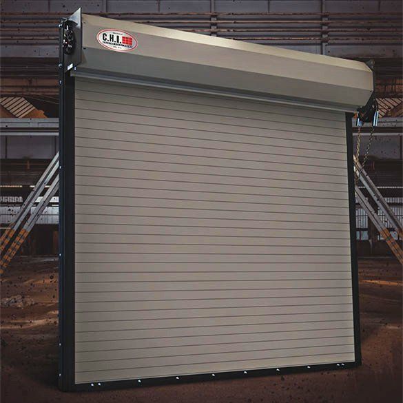 A roll up garage door is sitting in a warehouse.