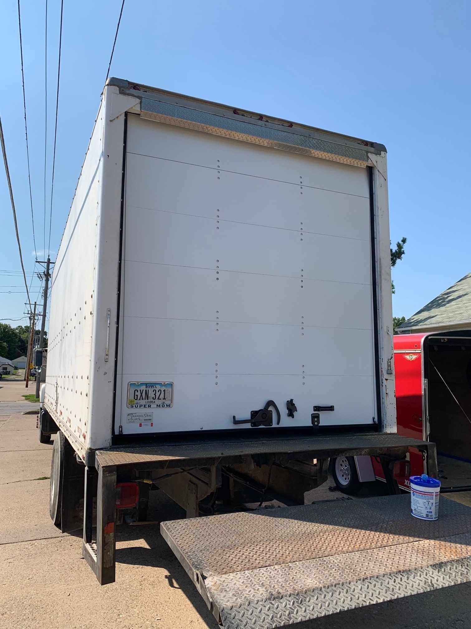 A white truck is parked on the side of the road.