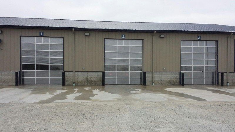 A row of garage doors on the side of a building