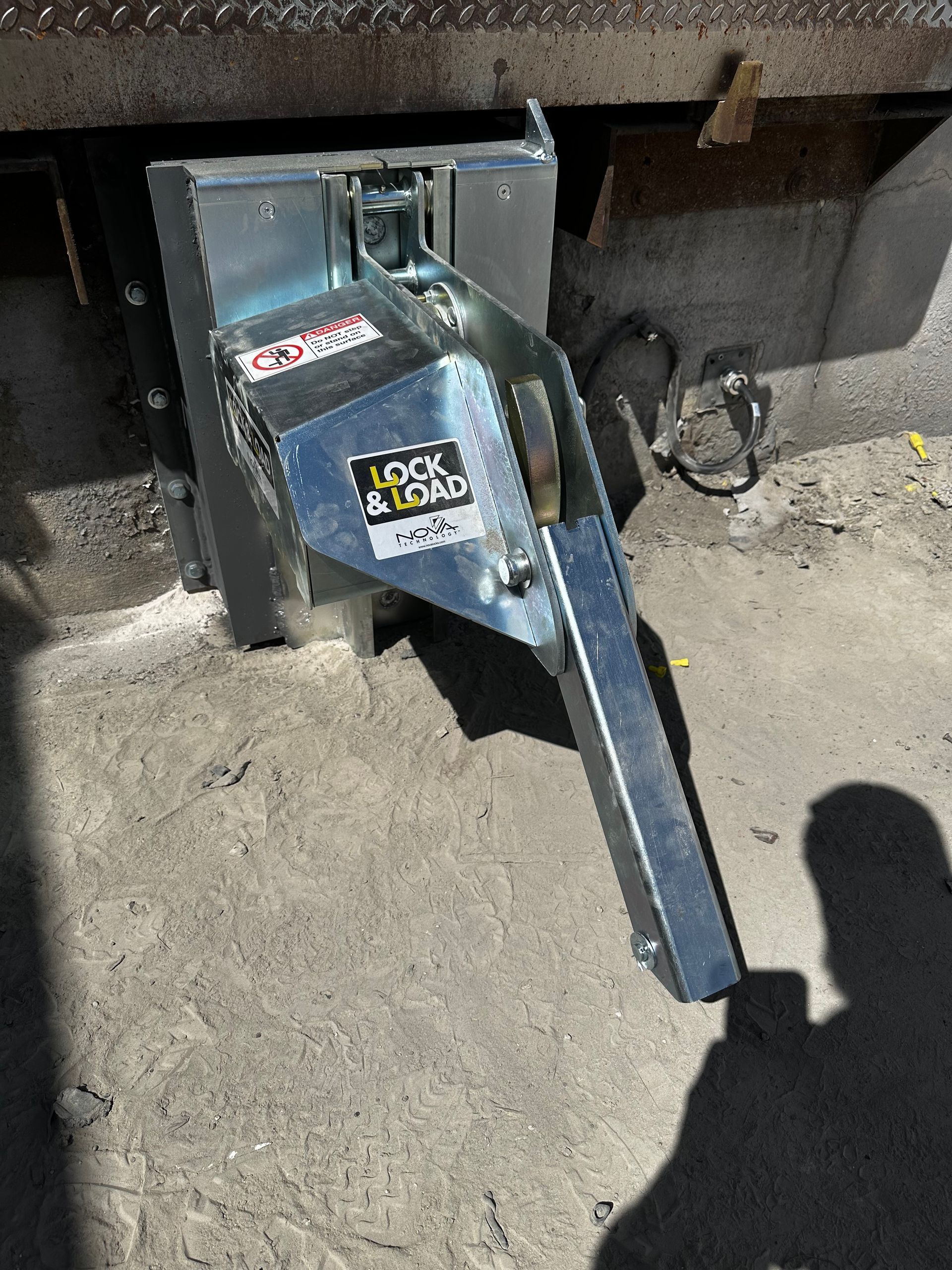 A metal object is sitting on the ground next to a truck.