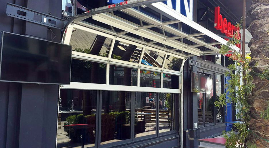 A building with a lot of windows and a tv on the side of it.