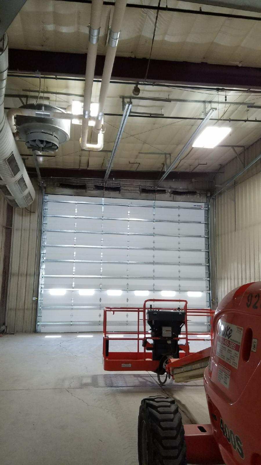 A large garage door is being installed in a building.