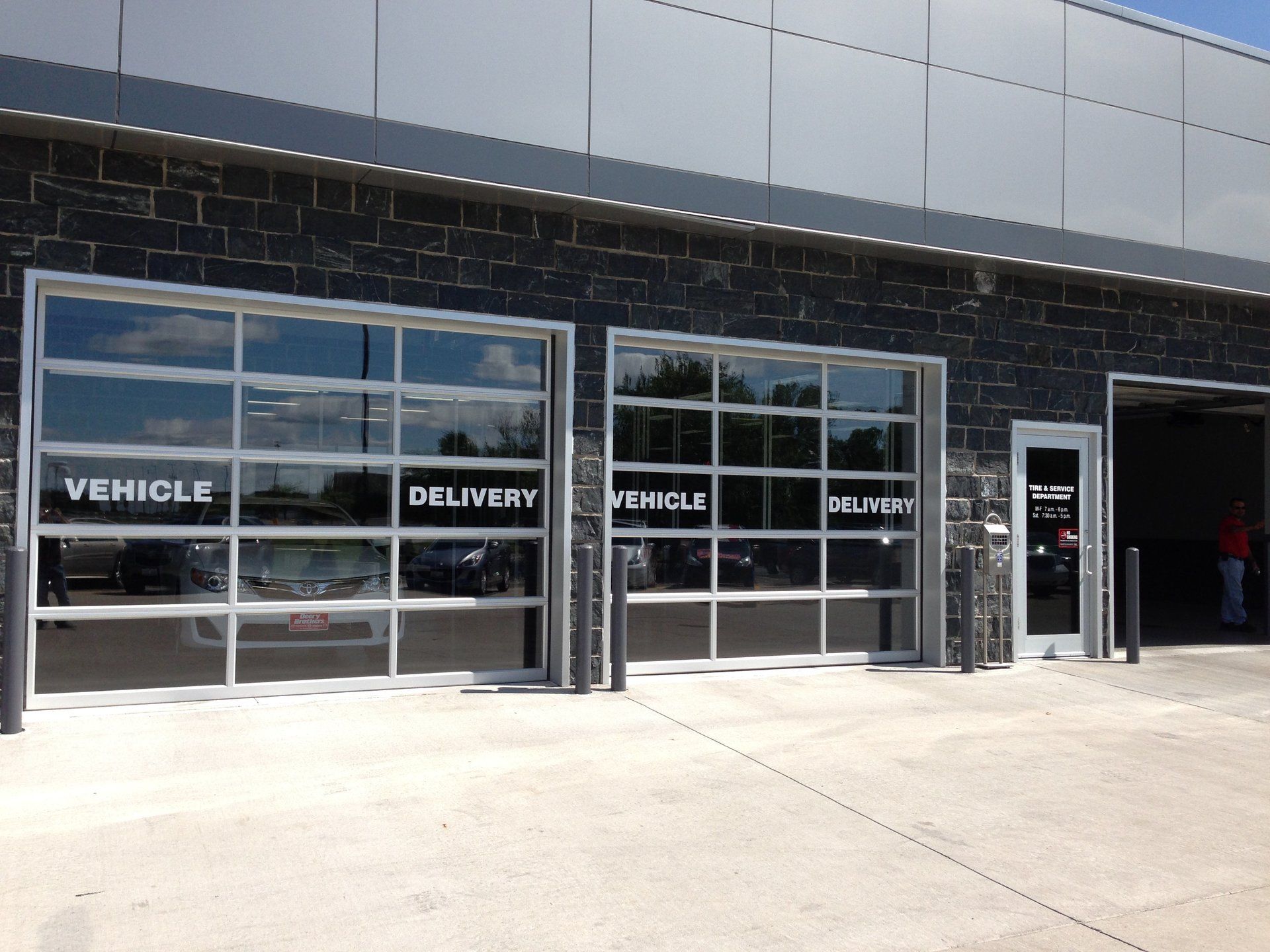 A building with a lot of windows and a sign that says vehicle delivery