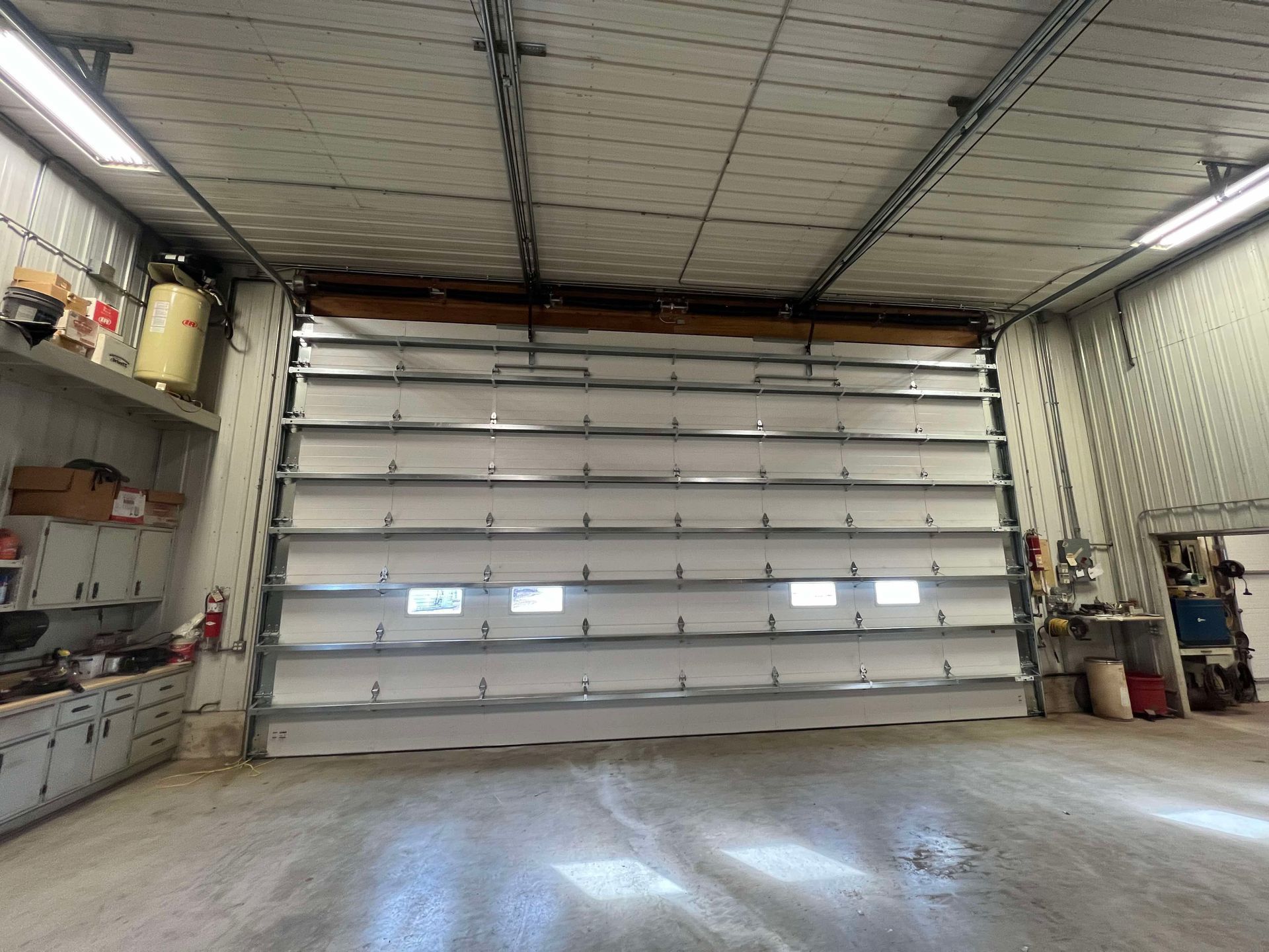 A garage with a large garage door open.