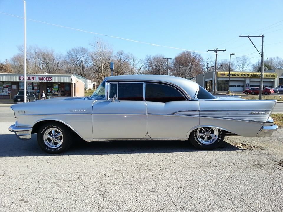 Classic silver two-door coupe parked in a lot on a sunny day