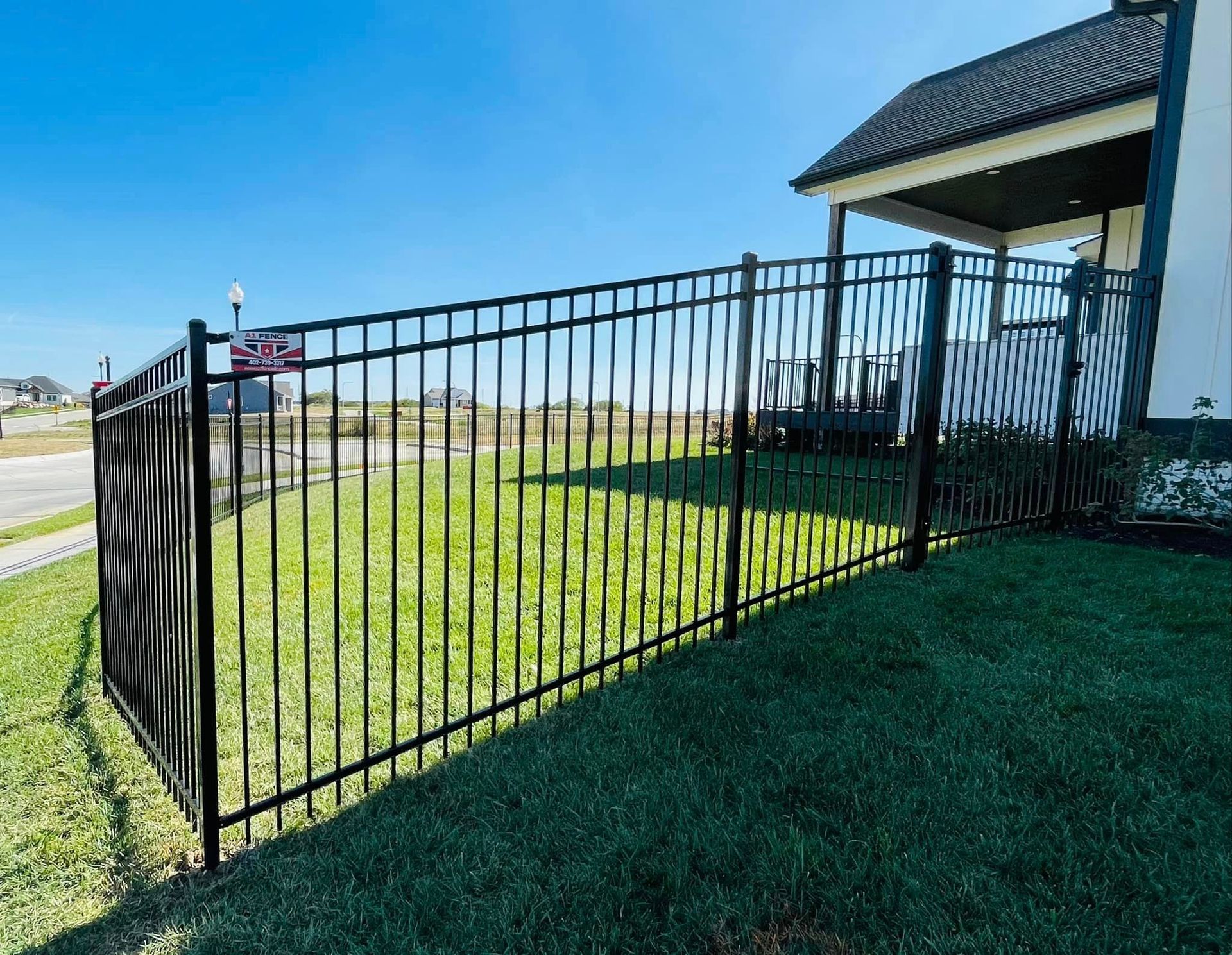 a black metal fence is in front of a house