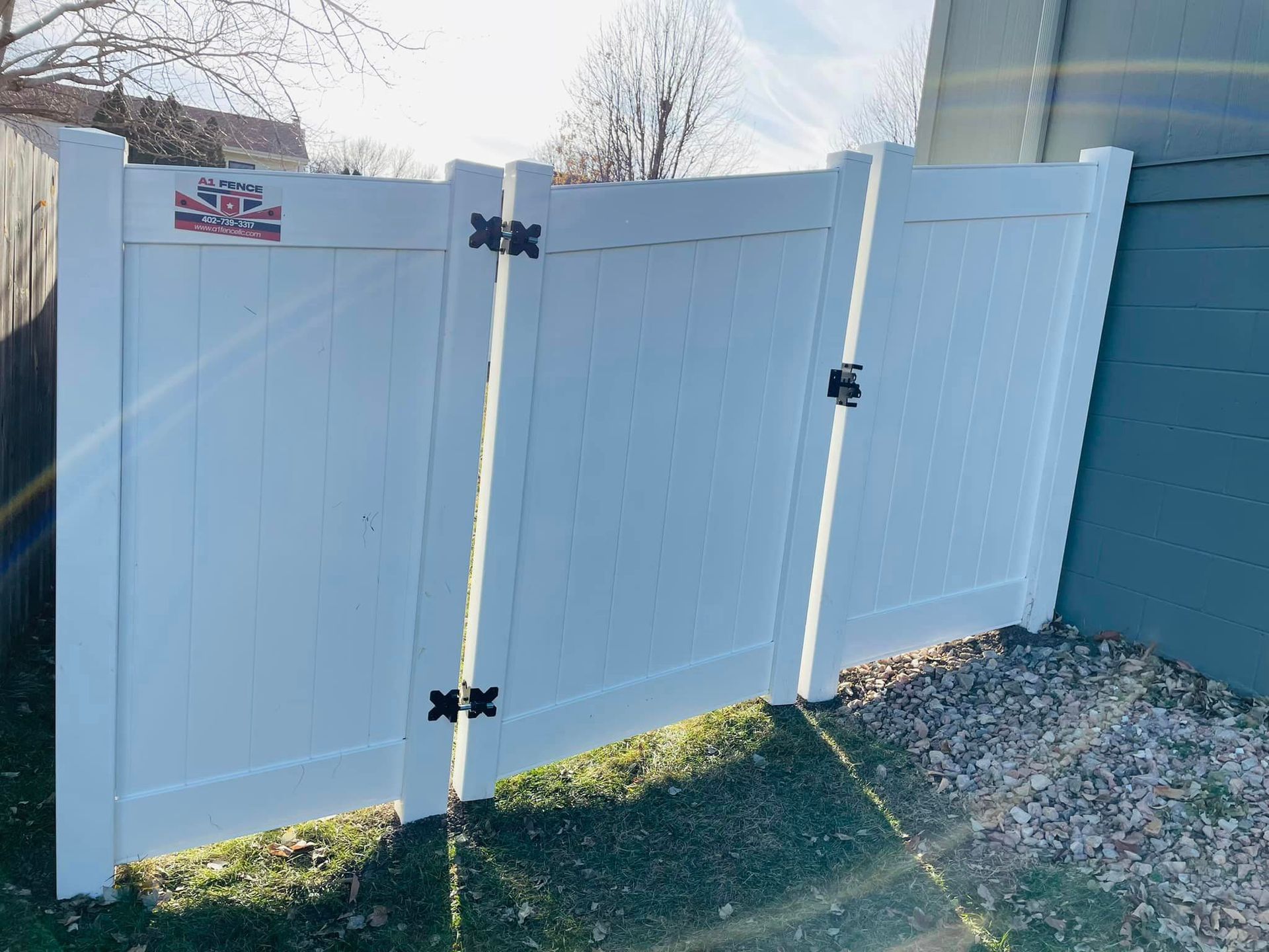 a white fence has a sticker on it that says A1 Fence