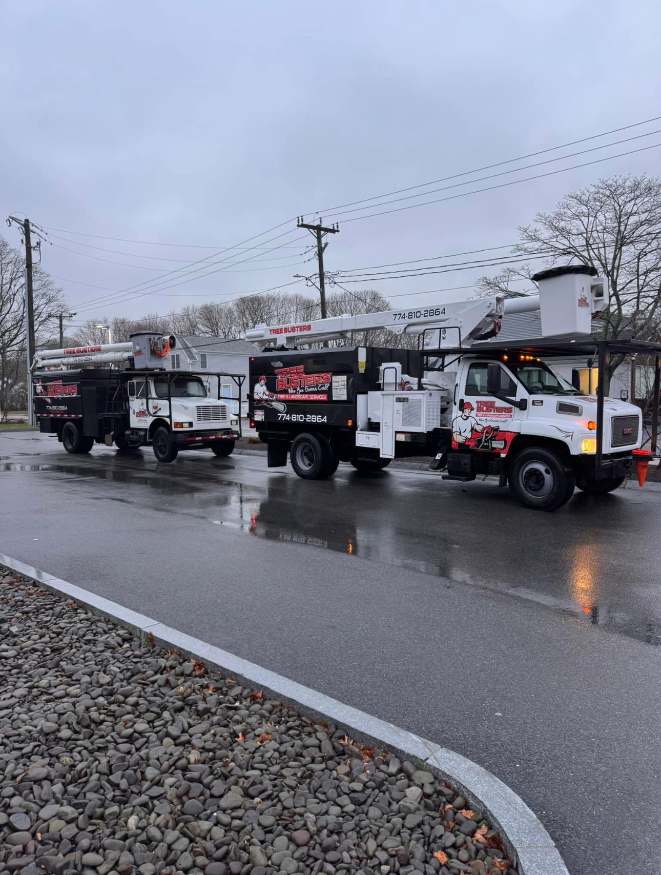 Three trucks are parked on the side of the road.