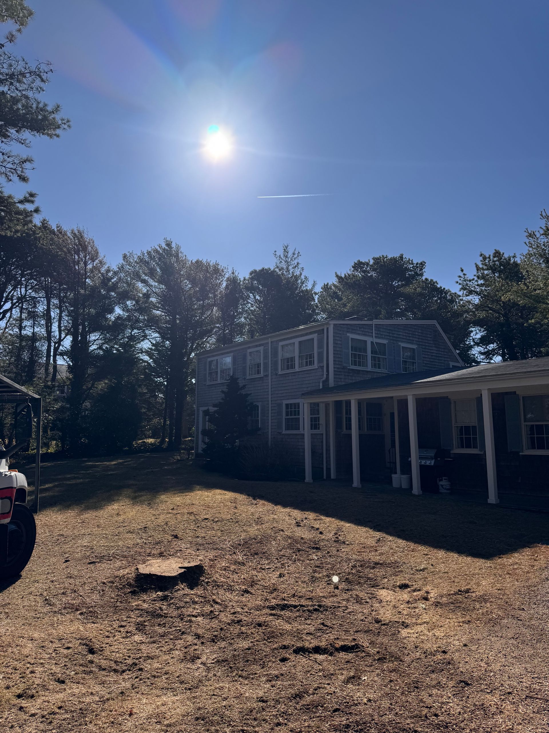 A large house with a tractor parked in front of it.