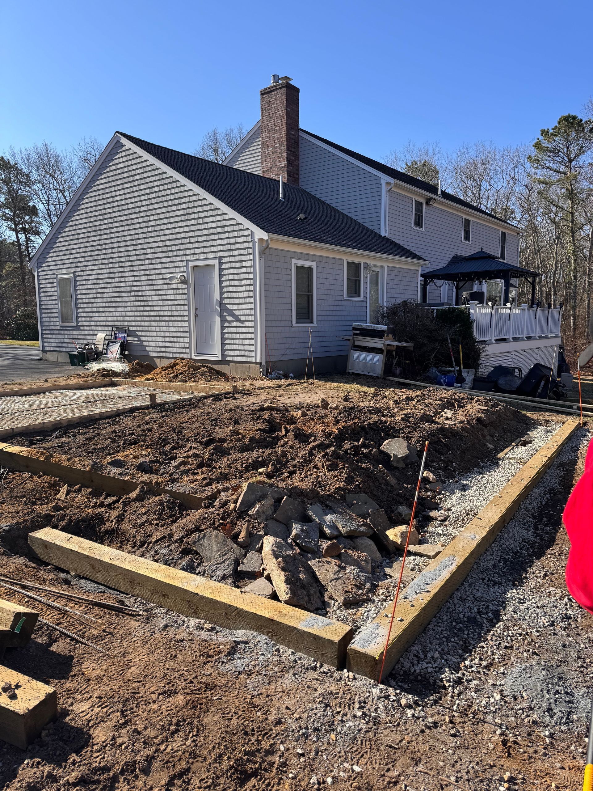 A house is being built in the middle of a dirt field.