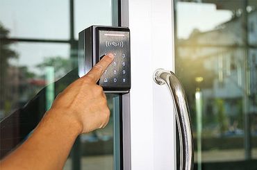 Hand pressing numbers to lock and unlock door