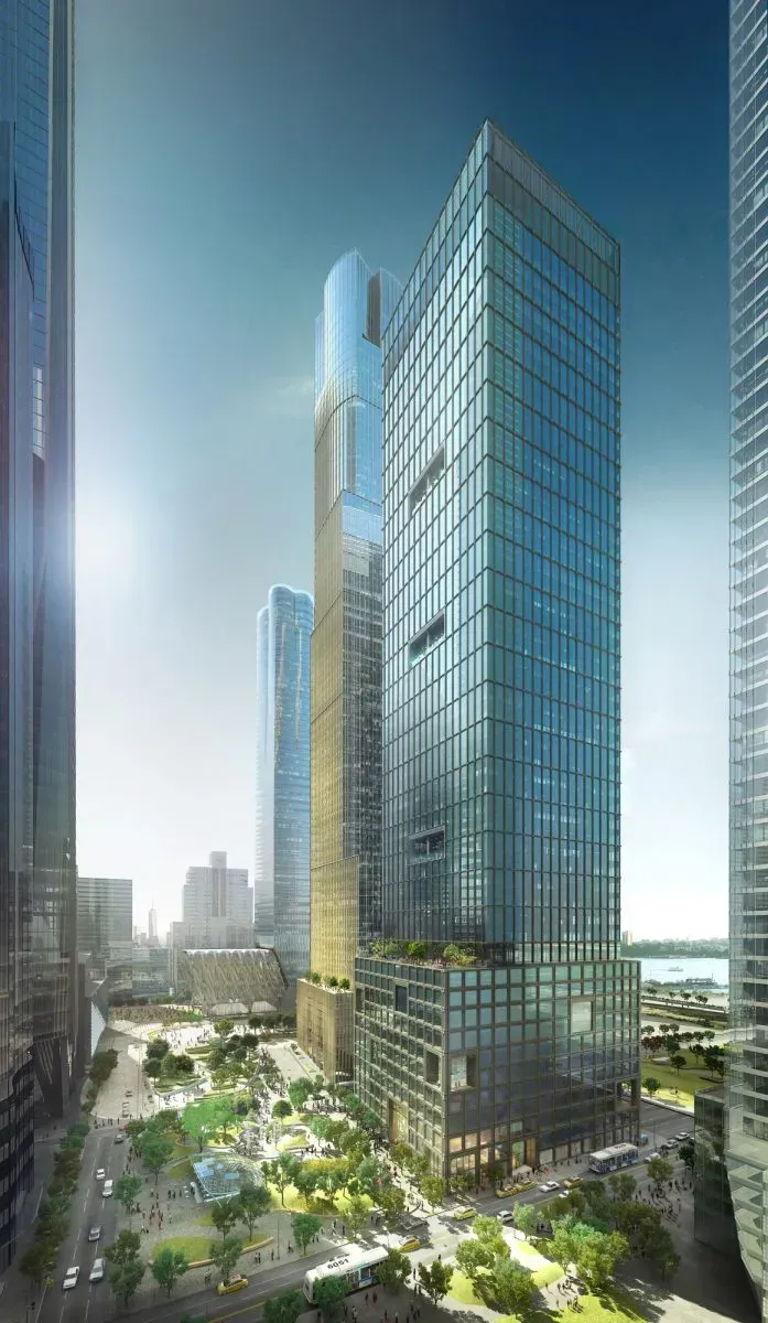 Glass high-rise towers in a modern city skyline with sunlight and trees below.